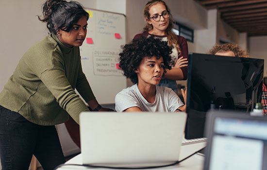 group of woman looking at screen