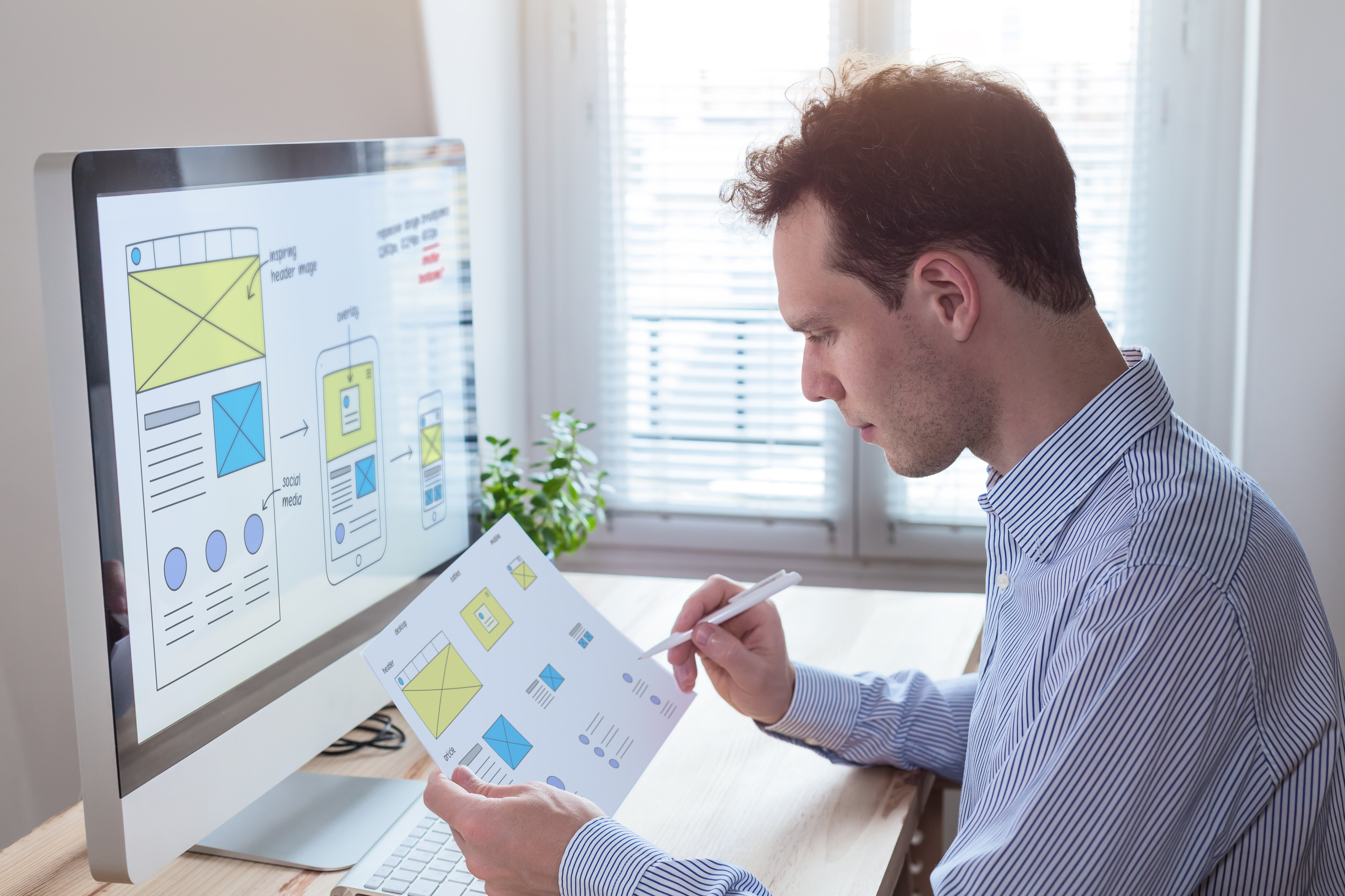 person looking at a sheet of paper with icons on