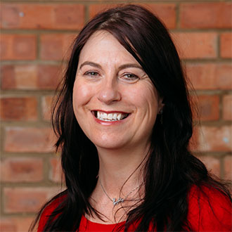 woman with long dark hair smiling