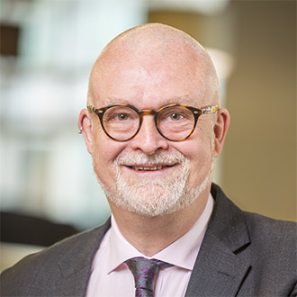 Man with beard and glasses smiling