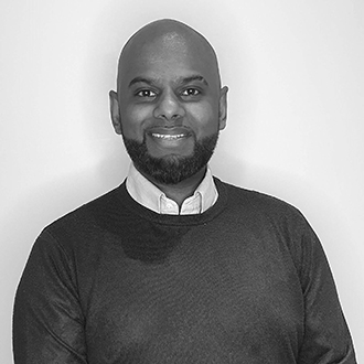 man with a beard smiling at the camera