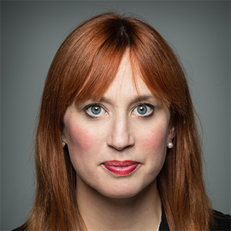 woman long red hair looking straight at the camera