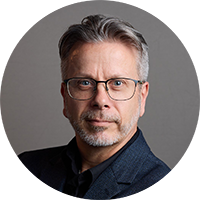 Person wearing glasses looking at the camera